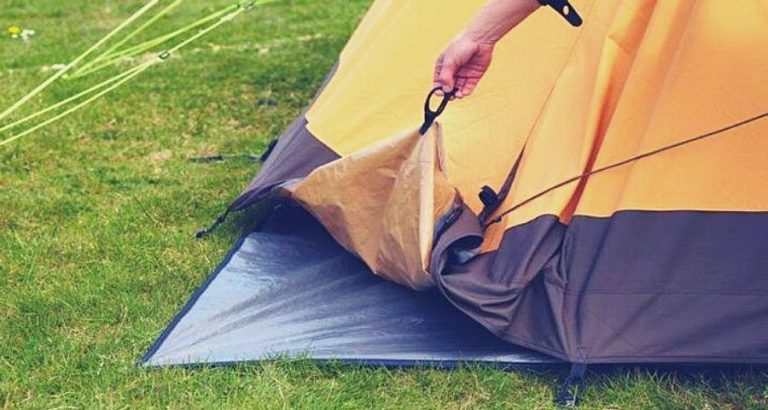 putting a tarp under a tent